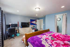 Carpeted bedroom with a textured ceiling