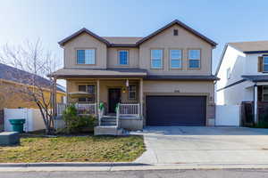 View of front of home featuring a porch and a garage