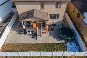 View of front facade with a patio and a trampoline