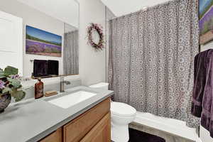 Bathroom featuring hardwood / wood-style floors, vanity, and toilet