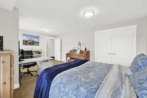 Carpeted bedroom with a closet