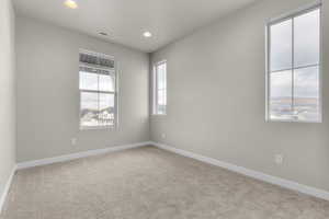Empty room featuring light carpet