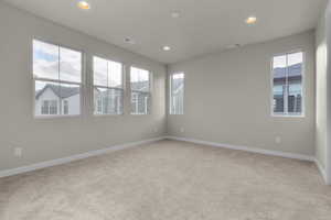Empty room featuring light carpet