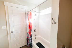 Bathroom featuring shower / tub combo with curtain