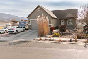 View of front of property featuring a mountain view and a garage