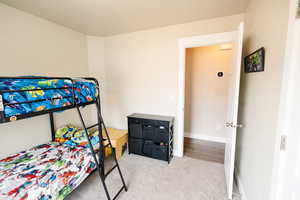 Bedroom featuring light carpet
