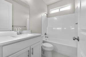 Full bathroom featuring vanity, shower / bathtub combination, and toilet