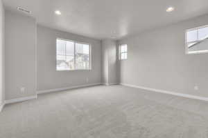 Unfurnished room with light colored carpet