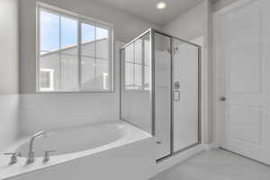 Bathroom featuring separate shower and tub