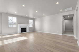 Unfurnished living room with a wealth of natural light and light hardwood / wood-style floors