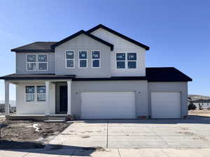 View of front facade featuring a garage