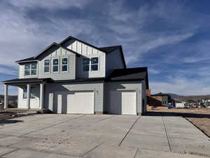 View of front of property featuring a porch and a garage