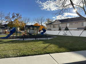 View of jungle gym with a lawn