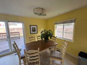 Dining room featuring light wood-type flooring and a healthy amount of sunlight