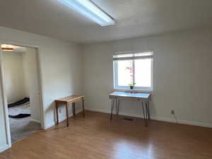 Spare room featuring a textured ceiling and light wood-type flooring