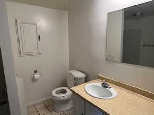 Bathroom with tile patterned floors, vanity, and toilet