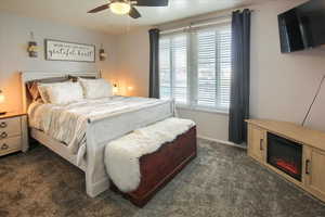 Main floor Carpeted bedroom with ceiling fan