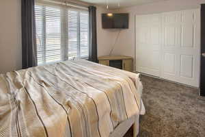 Main Floor Carpeted bedroom with a closet