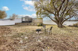 View of yard featuring a gazebo and an outdoor fire pit