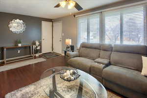 Living room with hardwood / wood-style floors and ceiling fan