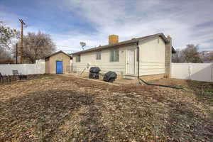 Back of property featuring a storage unit