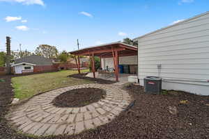 View of patio / terrace with a fire pit and cooling unit