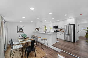 Dining room featuring dark hardwood / wood-style flooring and sink