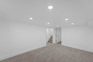 Basement featuring light carpet