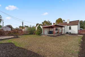 Rear view of property featuring a yard, a patio, and cooling unit