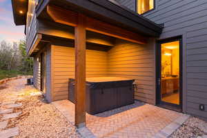 Patio terrace at dusk with a hot tub and central air condition unit