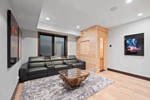 Living room with hardwood / wood-style floors and wooden walls