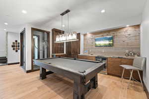 Rec room featuring wine cooler, light wood-type flooring, and pool table