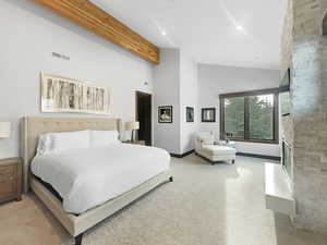 Bedroom with beam ceiling, light carpet, and high vaulted ceiling