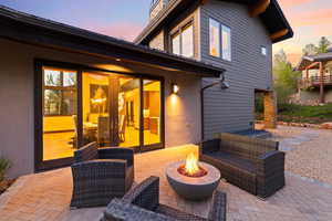 Patio terrace at dusk featuring french doors and an outdoor fire pit