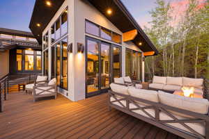 Deck at dusk featuring an outdoor hangout area