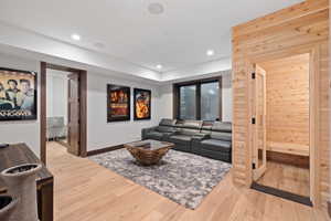 Living room featuring wooden walls and hardwood / wood-style floors