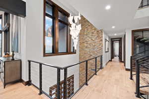 Corridor with light hardwood / wood-style floors and plenty of natural light