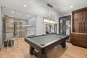 Game room with light wood-type flooring and billiards