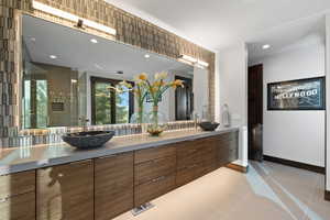 Bathroom with tile patterned flooring, vanity, and an enclosed shower