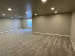 Interior space featuring carpet and a textured ceiling