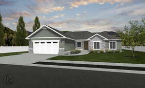 View of front of home featuring a lawn and a garage