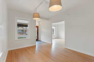 Entry and dining room with light hardwood flooring and lots of natural light