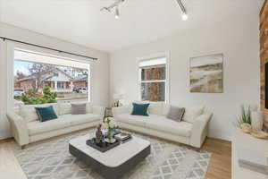 Front living room featuring light hardwood floors and lots of natural light