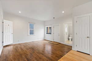 Family room with view of exterior door leading to front patio and garden space, main floor bathroom, and pantry