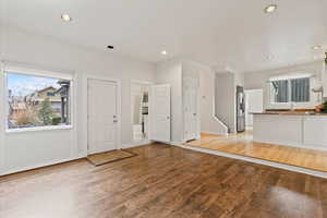 Family room with view of exterior door leading to front patio and garden space, and main floor bathroom