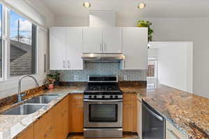 Kitchen featuring backsplash and gas stove