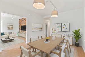 Dining room featuring track lighting and light hardwood flooring