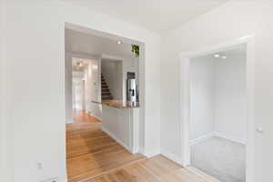 View from office/mudroom area near back door into storage room, and down the hall towards the front door