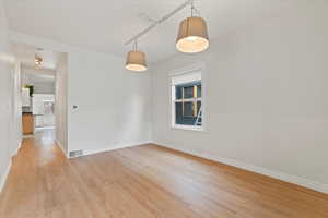 Dining room with light hardwood flooring