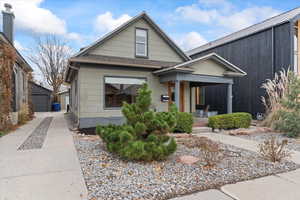 View of front facade featuring a garage, and covered porch